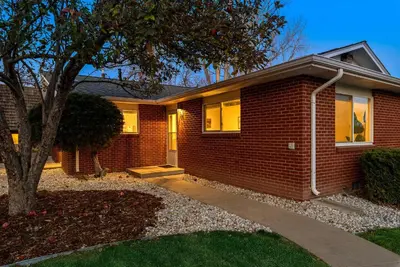 a brick house with a tree in front of it at Urban Oasis Near Old Town & PVH - Dog Friendly! in Fort Collins