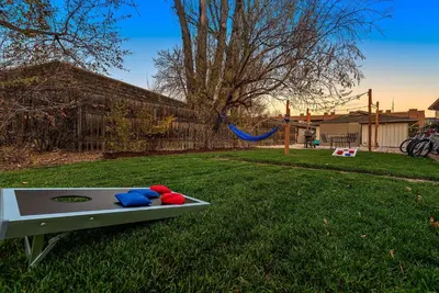 a ping pong table in a yard with a playground at Stylish Getaway with Designer Touches - Free Bikes in Fort Collins