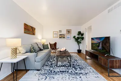a living room with a couch and a table at Ultimate Chill Zone, BBQ, Bikes, Pet Friendly!! in Fort Collins