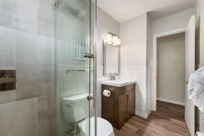 a bathroom with a toilet and a sink and a shower at Modern & Chic Condo in the Heart of Old Town in Fort Collins