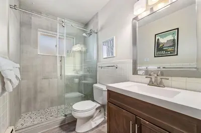 a bathroom with a shower and a toilet and a sink at Gorgeous Condo in the Heart of Old Town in Fort Collins
