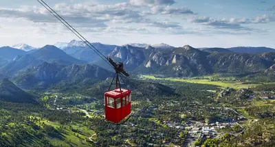 a red cable car flying in the mountains at Estes Escape – Jacuzzi, Indoor/Outdoor Fireplace and BBQ Grill in Estes Park