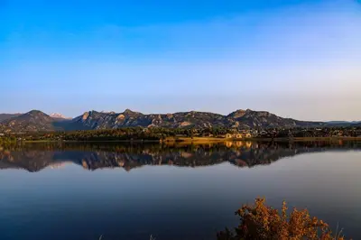 a view of a lake with mountains in the background at Estes Escape – Jacuzzi, Indoor/Outdoor Fireplace and BBQ Grill in Estes Park