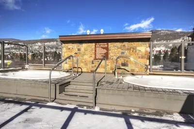 a building with two juzzled hot tubs in front at 2800 Slopeside condo in Keystone