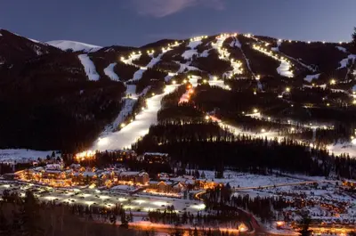 a ski resort with lights on a mountain at night at Black Bear 2 Bed 2 Bath BBCS in Dillon