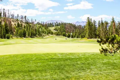 a view of a golf course with a green at Jackpine Lodge by Summit County Mountain Retreats in Keystone