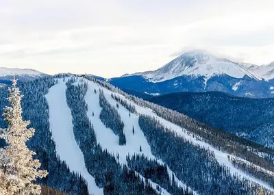 a view of a snow covered mountain range with trees at Alders by Summit County Mountain Retreats in Keystone