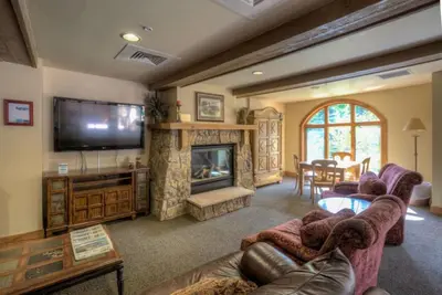 a living room with couches and a tv and a fireplace at Red Hawk Townhomes by Summit County Mountain Retreats in Keystone