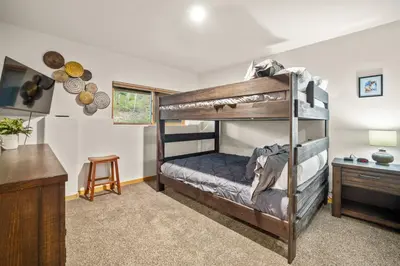 a bedroom with two bunk beds and a desk at Cutty Sark Court #1 3BR Mountain Views townhouse in Silverthorne