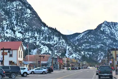 a town with cars parked on a street with mountains at Deming Crossing Duplex: Downtown Frisco Chic in Frisco