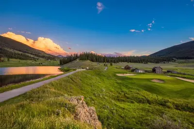 a view of a golf course with a pond at Family - Friendly 3 Bedroom In River Run Village With Mountain View in Keystone