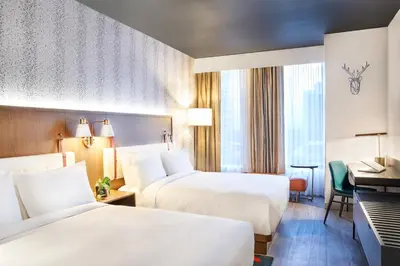 a hotel room with two beds and a desk at Hyatt Centric Downtown Denver in Denver