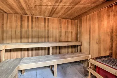 a wooden sauna with a bench in a room at Ski Shuttle and Pool Modern Silverthorne Condo! in Silverthorne