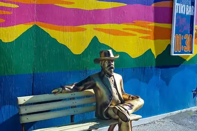 a statue of a man in a hat sitting on a bench at Watch Hill #524 - Wildernest in Silverthorne