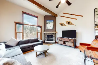 a living room with a couch and a tv at Red Hawk Townhome 2350 in Keystone