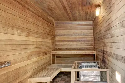 a sauna with wooden walls and benches in a room at 3066 Timbers condo in Keystone