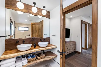 a bathroom with two sinks and a mirror at Gorgeous Views! Two large Patios, Jacuzzi, Indoor/Outdoor Fireplace in Estes Park