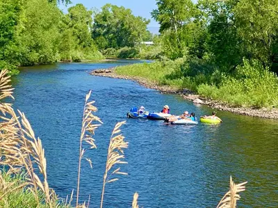 a group of people riding on tubes down a river at Vibrant Downtown Bungalow - Walk Everywhere! in Fort Collins