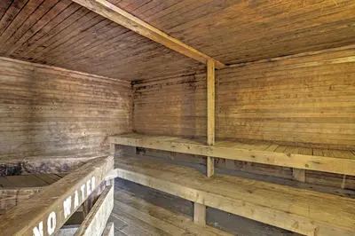 an empty sauna with wooden walls and wooden benches at 2 Mi to Granby Ranch Resort Studio with Pool Access in Granby