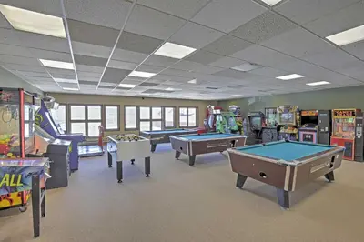 a room with several arcade games and pool tables at 2 Mi to Granby Ranch Resort Studio with Pool Access in Granby