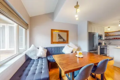 a living room with a blue couch and a wooden table at At the Crossroads in Frisco