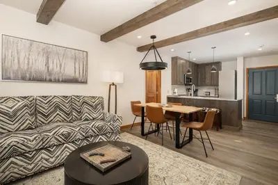 a living room with a couch and a table at Beautiful Zephyr Mountain Lodge condo with Slope Base View condo in Winter Park