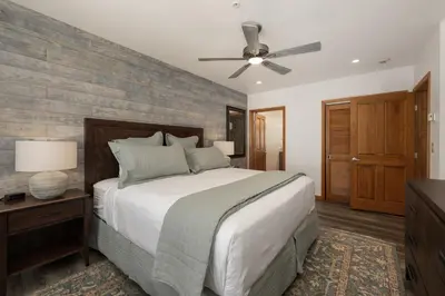 a bedroom with a bed and a ceiling fan at Beautiful Zephyr Mountain Lodge condo with Slope Base View condo in Winter Park