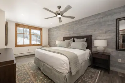 a bedroom with a bed and a ceiling fan at Beautiful Zephyr Mountain Lodge condo with Slope Base View condo in Winter Park