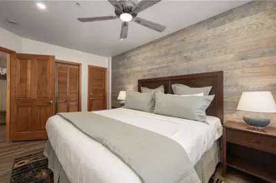 a bedroom with a large bed and a ceiling fan at Beautiful Zephyr Mountain Lodge condo with Slope Base View condo in Winter Park