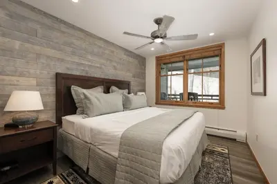 a bedroom with a bed and a ceiling fan at Beautiful Zephyr Mountain Lodge condo with Slope Base View condo in Winter Park