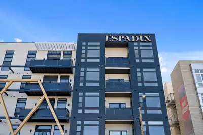 a building with a sign on the side of it at Art-Inspired Loft with Mountain View - Zuni Lofts in Denver
