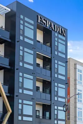 a building with a sign on the side of it at Modern Eclectic Penthouse Loft - Zuni Lofts in Denver