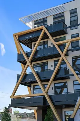 a building with wooden balconies on the side of it at Fifty Shapes of Modern - Skyline Loft - Zuni Lofts in Denver