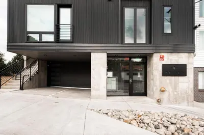 a black house with a black roof at Luxurious Escape - Walk to Empower Field - Tesoro in Denver