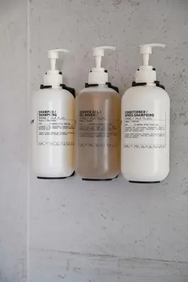 a group of three lotion bottles on a shelf at Brand New Condo - Walk to Empower Stadium - Tesoro in Denver