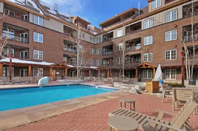 a swimming pool in front of a building at Dakota Lodge in Keystone