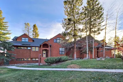 a large brick house with a driveway at Soda Springs Condominiums in Keystone