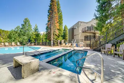a large swimming pool with a resort style building at Chic Winter Park Studio with Community Hot Tub in Winter Park