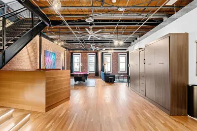an office space with wood floors and a brick wall at Hotel Residential of Denver in Denver