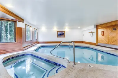 a pool in a house with a hot tub at 309 Snowdance Manor condo in Keystone