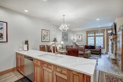 a kitchen with a white counter top and a living room at One-Bedroom Apartment in Dillon