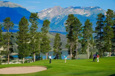 a group of people playing golf on a golf course at One-Bedroom Apartment in Dillon