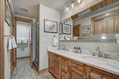 a bathroom with two sinks and a shower at One-Bedroom Apartment in Dillon