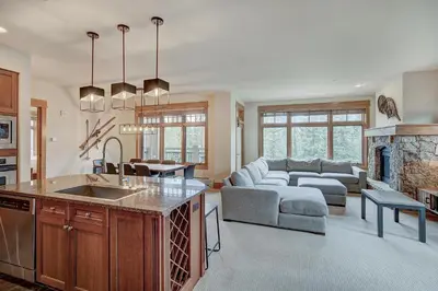 a kitchen and living room with a couch and a table at Luxurious 3 BR in River Run Village with Ski-In Out condo in Dillon