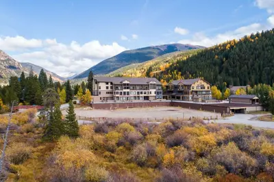 an aerial view of a large building with mountains in the background at 2767 Slopeside condo in Keystone