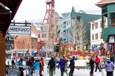 a group of people walking down a city street at 1 Bedroom Mountain Condo In River Run Village With Expansive Mountain Views And Walking Distance To Ski Slopes in Keystone