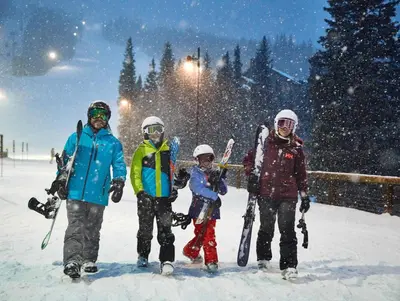 a group of people standing in the snow at Luxurious 2 BR in River Run Village Featuring Ski in ski-out condo in Dillon