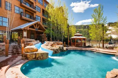 a pool in a yard with a gazebo at Beautiful 2 Bedroom Mountain Condo In River Run Village With Hot Tub Access And Walking Distance To The Gondola in Keystone