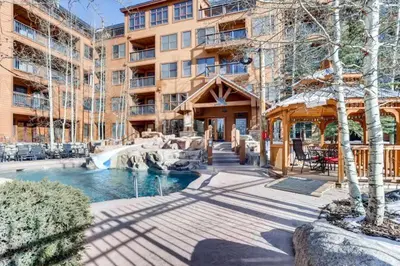a resort with a pool and a fountain and a building at Beautiful 2 Bedroom Mountain Condo In River Run Village With Hot Tub Access And Walking Distance To The Gondola in Keystone