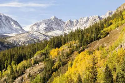 a mountain valley with trees and snow covered mountains at Family Friendly 3 Bedroom Vacation Rental In West Keystone Resort Along The Snake River With Pool And Hot Tub in Keystone